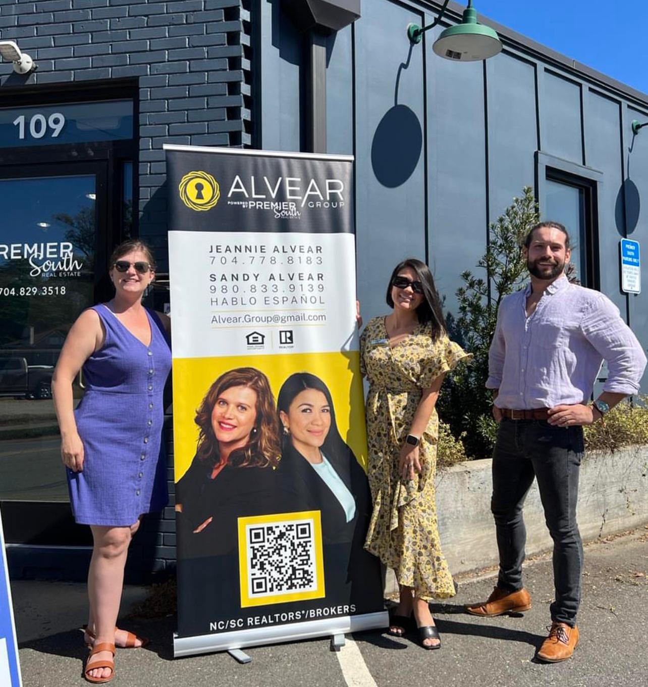 Jeannie and Sandy Alvear with clients outside Premier South Real Estate office